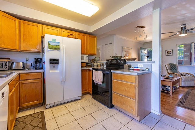 kitchen with light wood-type flooring, ornamental molding, white appliances, kitchen peninsula, and ceiling fan