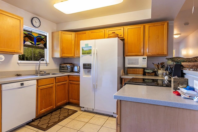 kitchen with white appliances, light tile patterned floors, and sink