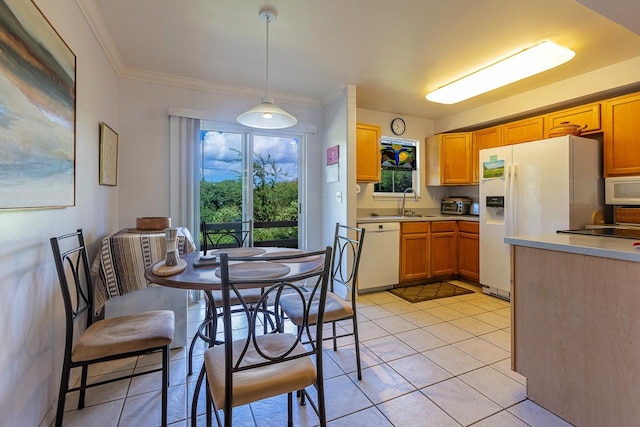 kitchen featuring white appliances, crown molding, hanging light fixtures, sink, and light tile patterned flooring