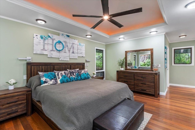 bedroom with a tray ceiling, ceiling fan, hardwood / wood-style floors, and crown molding