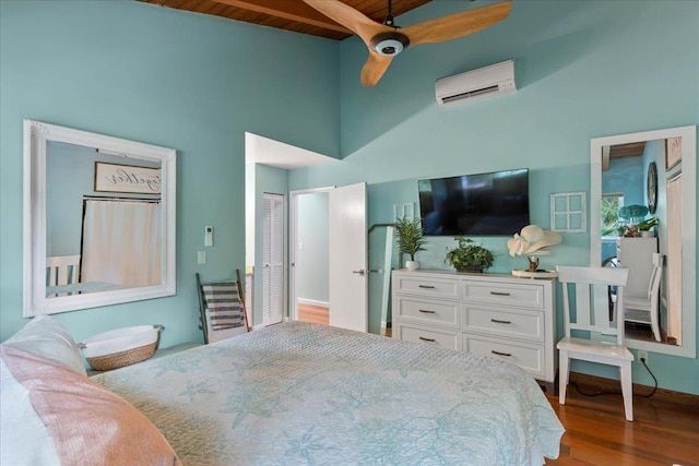 bedroom featuring a wall mounted air conditioner, wooden ceiling, a high ceiling, ceiling fan, and wood-type flooring