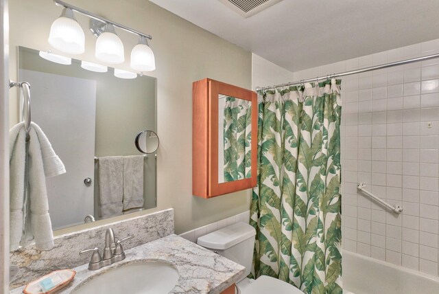 full bathroom with vanity, toilet, and shower / bath combo with shower curtain