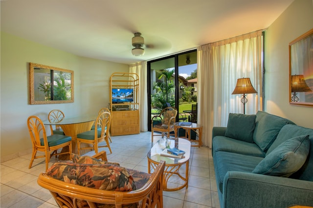 living room featuring a wealth of natural light, ceiling fan, and light tile patterned floors