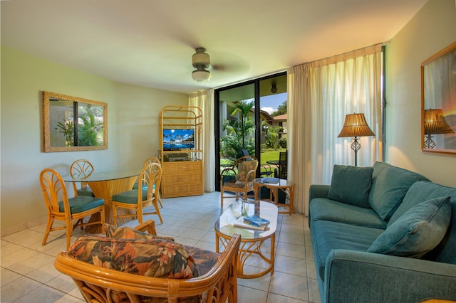 49 W Lipoa St Unit 107, Kihei, HI 96753 - living area with light tile patterned floors, a ceiling fan, and expansive windows