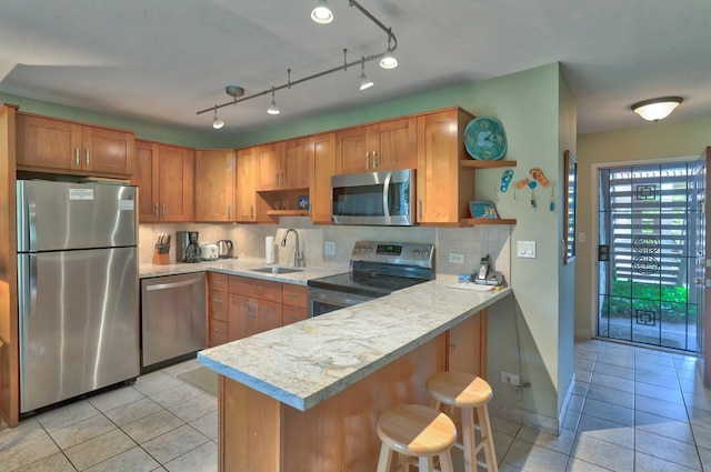 49 W Lipoa St Unit 107, Kihei, HI 96753 - kitchen with stainless steel appliances, open shelves, light tile patterned floors, and light countertops