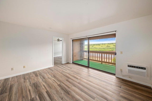 spare room with hardwood / wood-style floors and ceiling fan