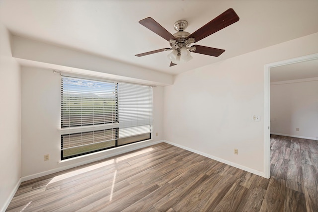 unfurnished room with ceiling fan and dark hardwood / wood-style floors