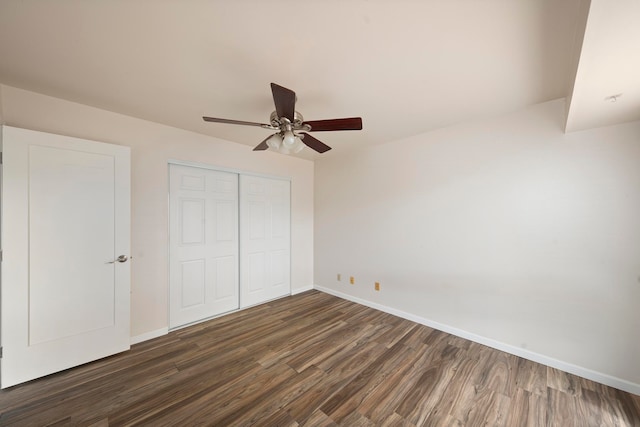 unfurnished bedroom featuring a closet, ceiling fan, and dark hardwood / wood-style floors