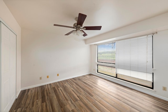 spare room with hardwood / wood-style floors and ceiling fan