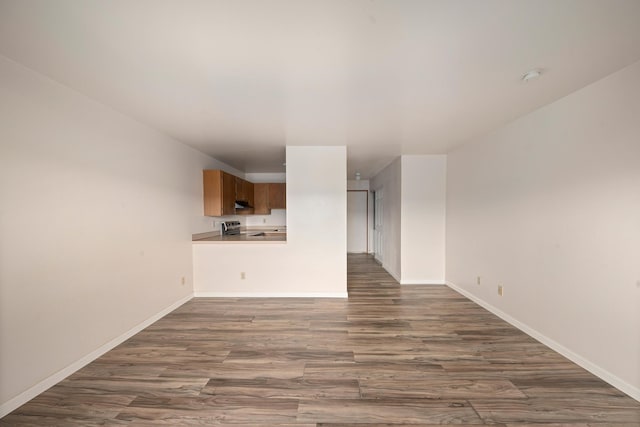 unfurnished living room with dark hardwood / wood-style flooring