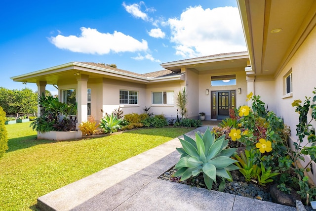 doorway to property with a yard