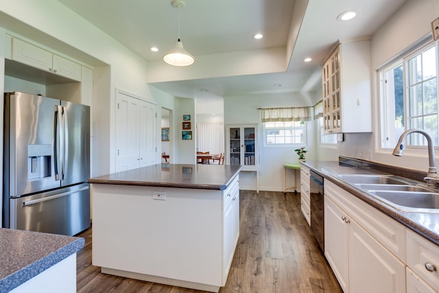 kitchen with sink, a center island, stainless steel fridge with ice dispenser, and white cabinets