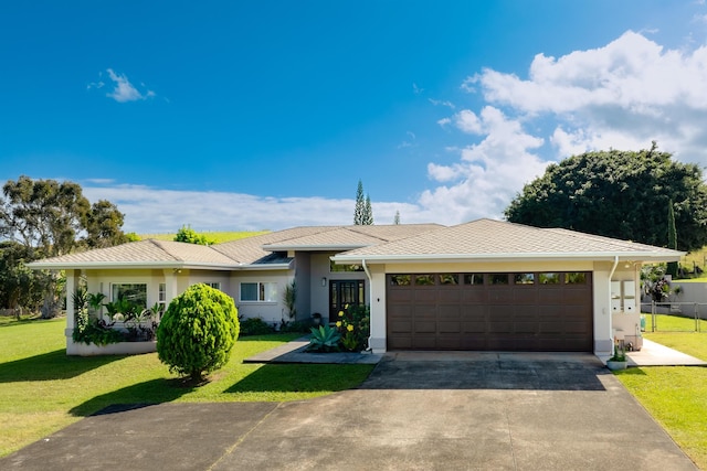 view of front of home featuring a garage and a front yard