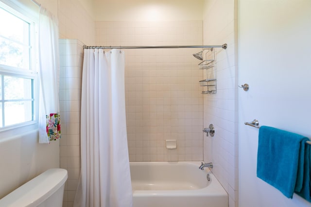 bathroom with shower / tub combo and toilet