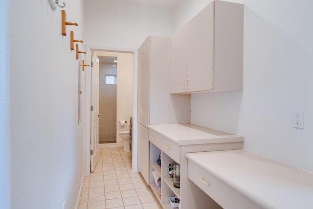 laundry room featuring light tile patterned flooring