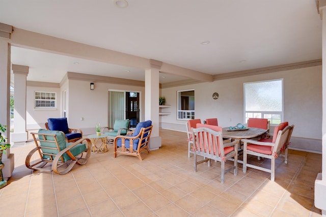 dining space featuring crown molding and light tile patterned floors