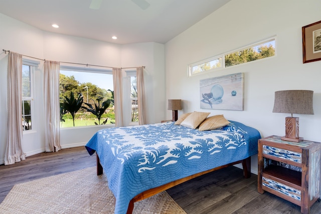 bedroom featuring multiple windows, hardwood / wood-style floors, and ceiling fan