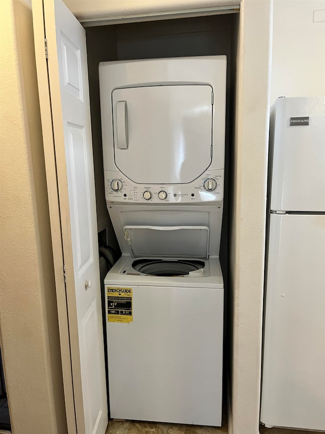 washroom featuring stacked washing maching and dryer