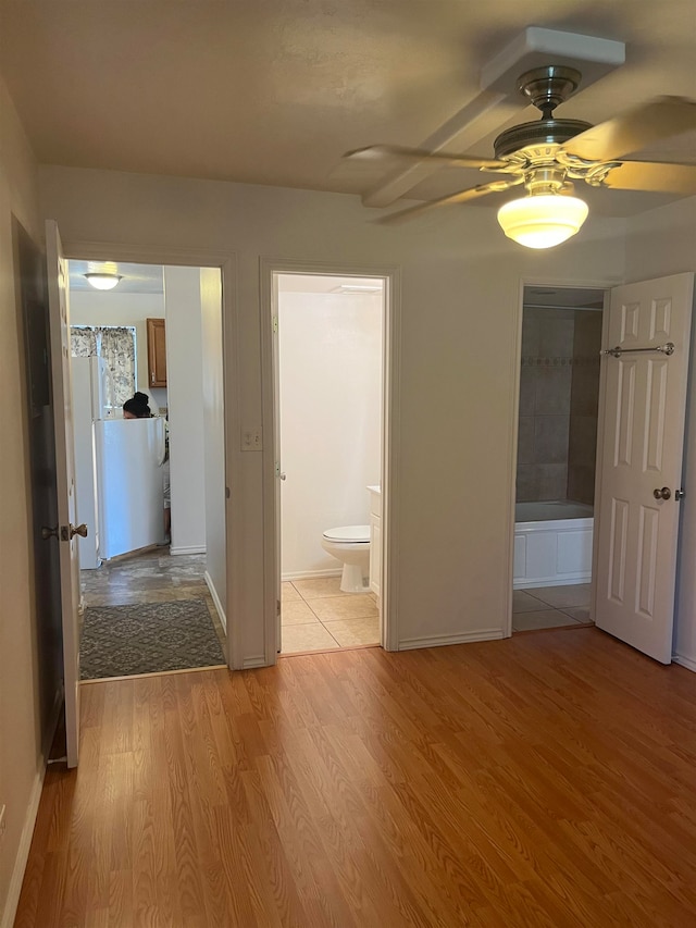 unfurnished room with ceiling fan and hardwood / wood-style floors