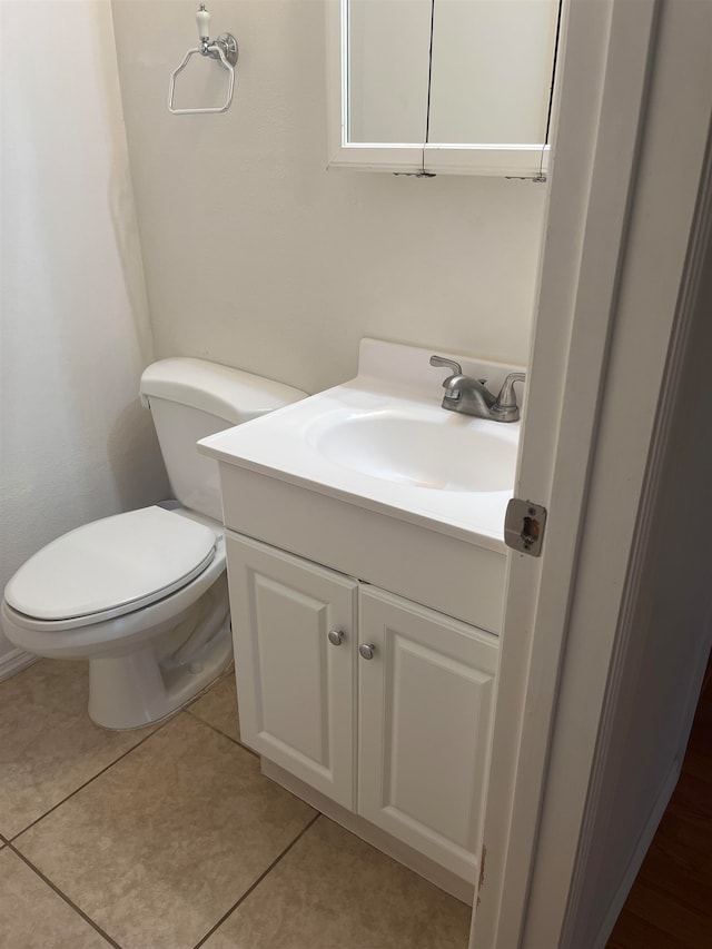 bathroom with vanity, toilet, and tile patterned floors