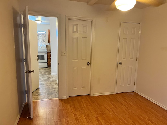 unfurnished bedroom with ceiling fan and light hardwood / wood-style flooring