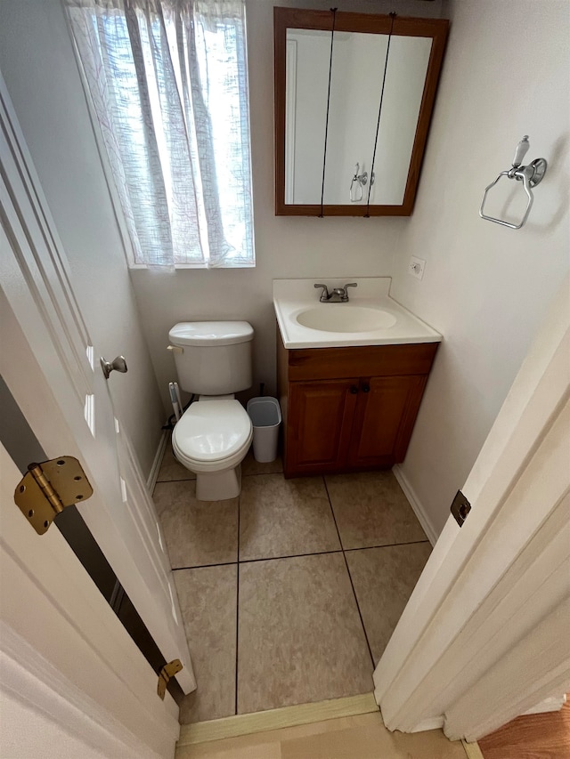 bathroom with vanity, toilet, and tile patterned flooring