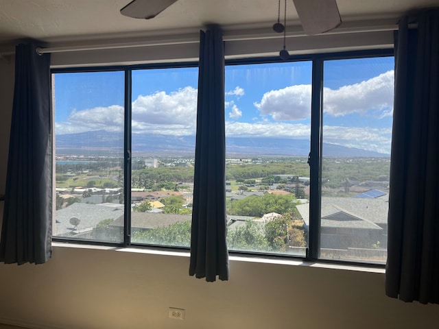 interior details with ceiling fan and a mountain view