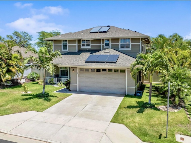view of front of house with covered porch, driveway, roof mounted solar panels, a front lawn, and a shingled roof