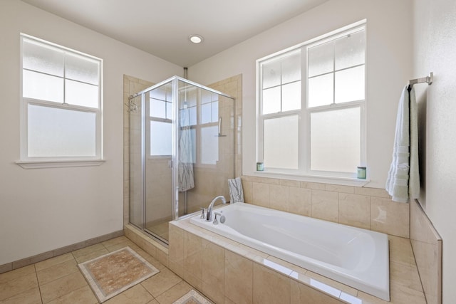 full bathroom with a garden tub, baseboards, tile patterned flooring, and a stall shower