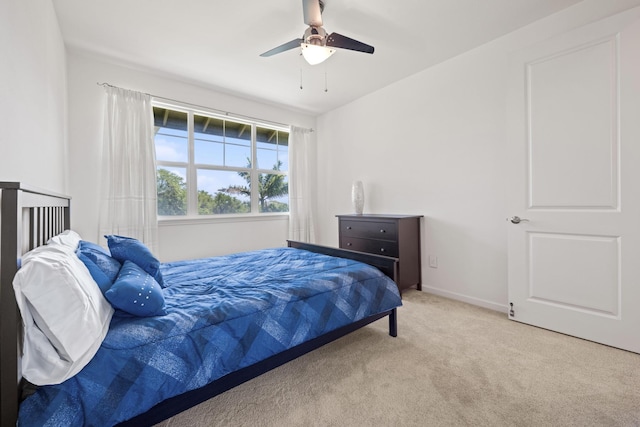 carpeted bedroom with baseboards and ceiling fan