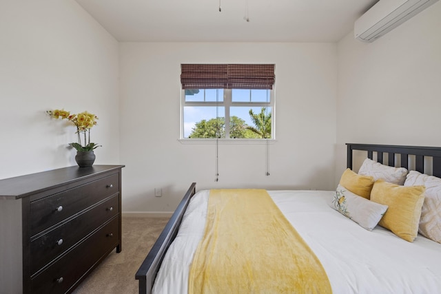 bedroom with carpet floors, a wall unit AC, and baseboards