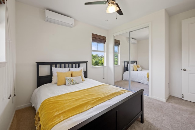 bedroom with baseboards, a closet, a wall unit AC, and light colored carpet