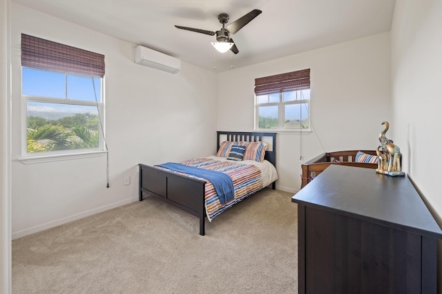 bedroom with light carpet, baseboards, ceiling fan, and an AC wall unit
