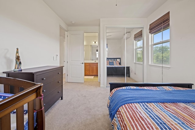 bedroom with light carpet and a closet