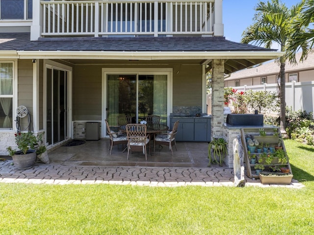 view of patio / terrace featuring a balcony and fence