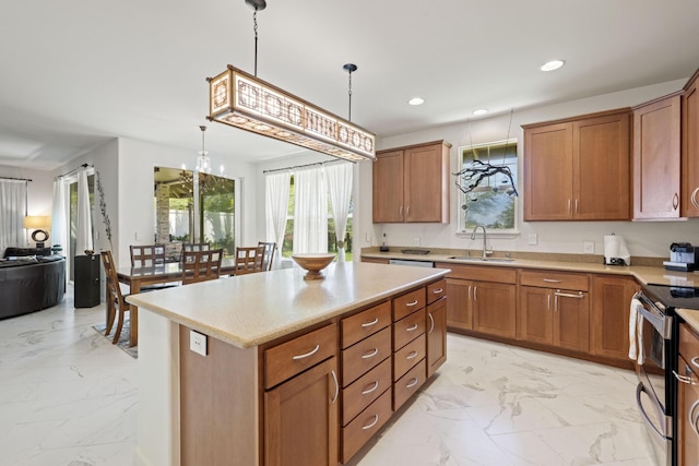 kitchen with marble finish floor, brown cabinets, a sink, and a wealth of natural light