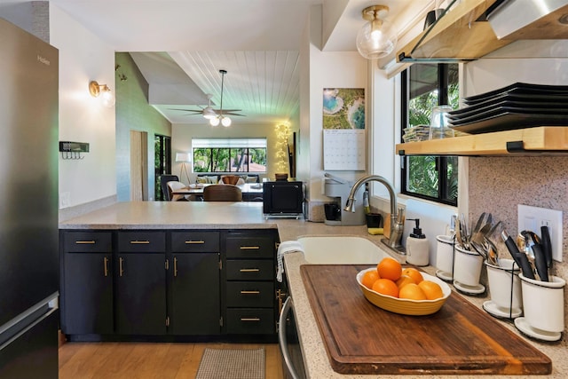 3788 Lower Honoapiilani Rd Unit E212, Lahaina, HI 96761 - kitchen with freestanding refrigerator, a sink, light countertops, a peninsula, and light wood-type flooring