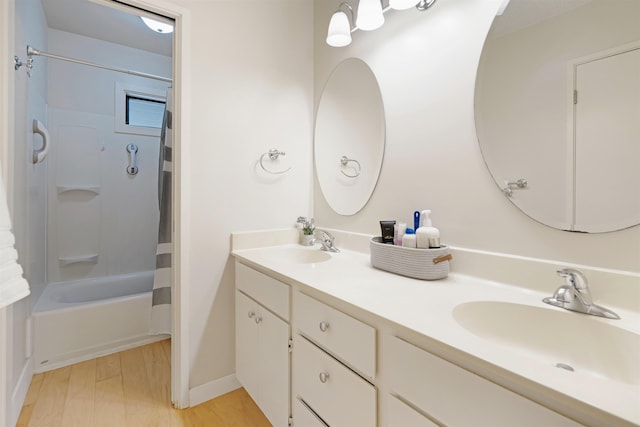 3788 Lower Honoapiilani Rd Unit E212, Lahaina, HI 96761 - bathroom featuring double vanity, shower / bath combo with shower curtain, wood finished floors, and baseboards