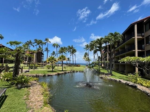 exterior space featuring a lawn and a water view