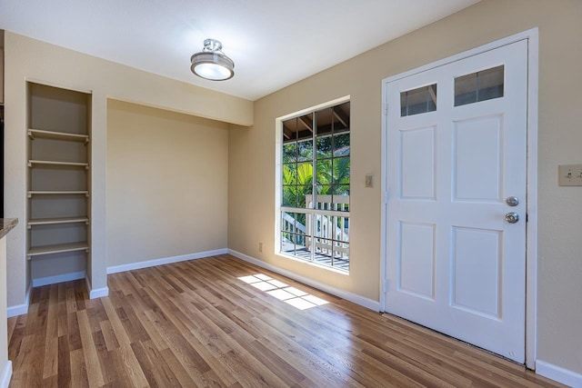 interior space featuring wood finished floors and baseboards