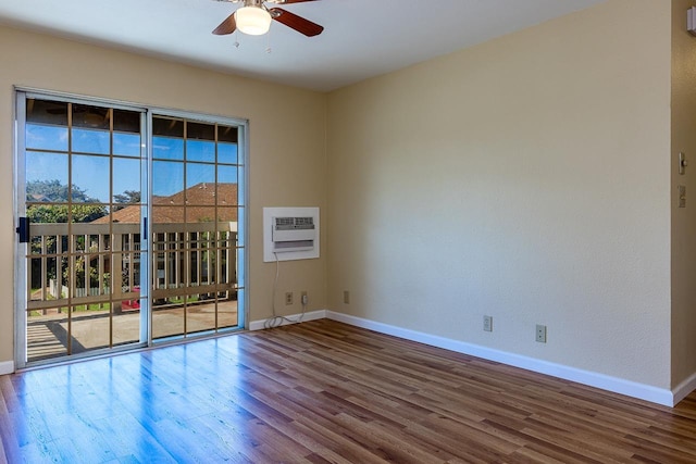 unfurnished room with baseboards, wood finished floors, ceiling fan, and an AC wall unit