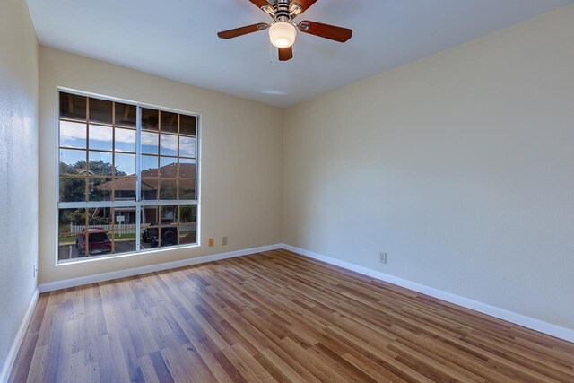 empty room featuring wood-type flooring and ceiling fan