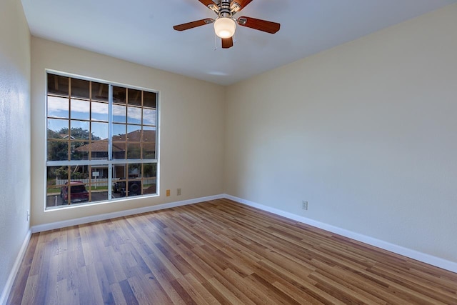 unfurnished room featuring wood finished floors and baseboards
