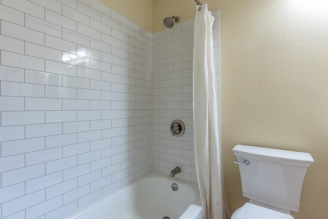 bathroom with toilet and shower / bath combo