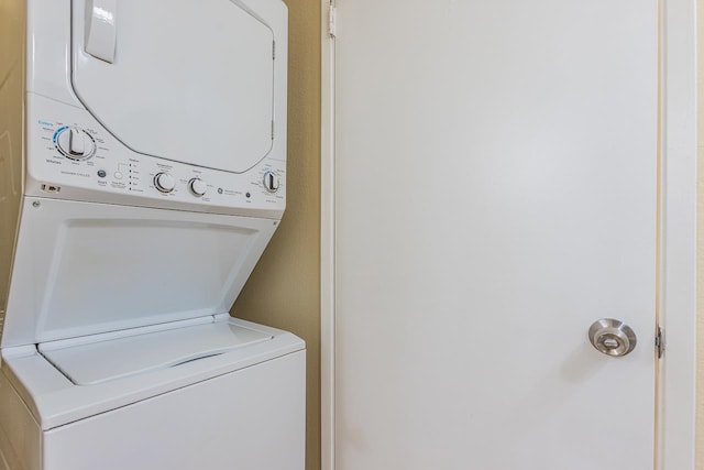 laundry room with stacked washer and dryer and laundry area