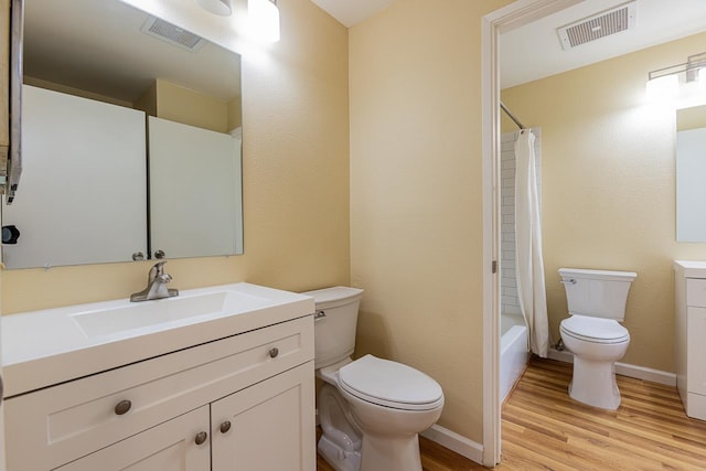 full bathroom featuring vanity, toilet, hardwood / wood-style flooring, and shower / bath combo with shower curtain