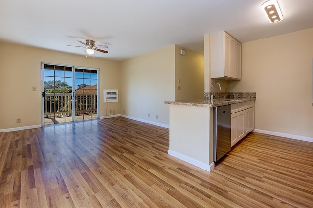 kitchen with white cabinetry, stainless steel dishwasher, light wood-style flooring, a sink, and ceiling fan