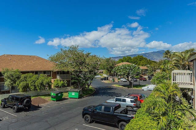 view of vehicle parking featuring a mountain view