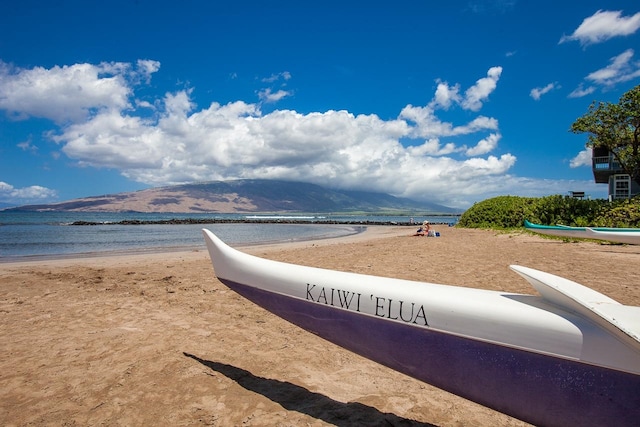 water view featuring a mountain view and a beach view