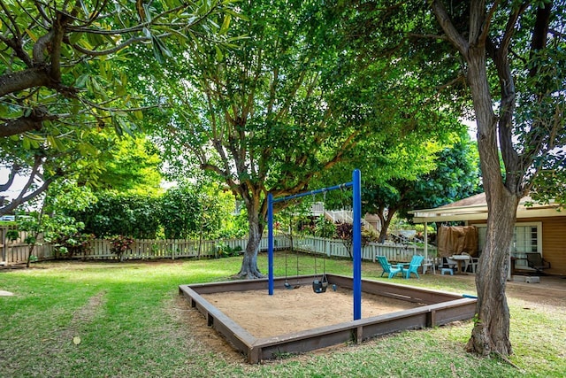 surrounding community featuring a lawn, playground community, and a fenced backyard